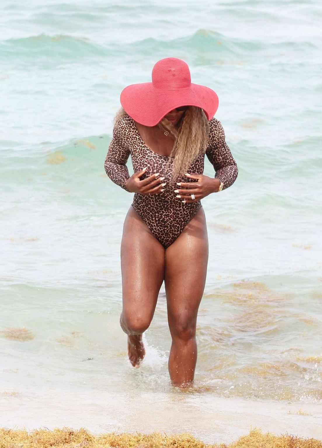 16P Serena Williams shows off her curvy body wearing a leopard print swimsuit on a b