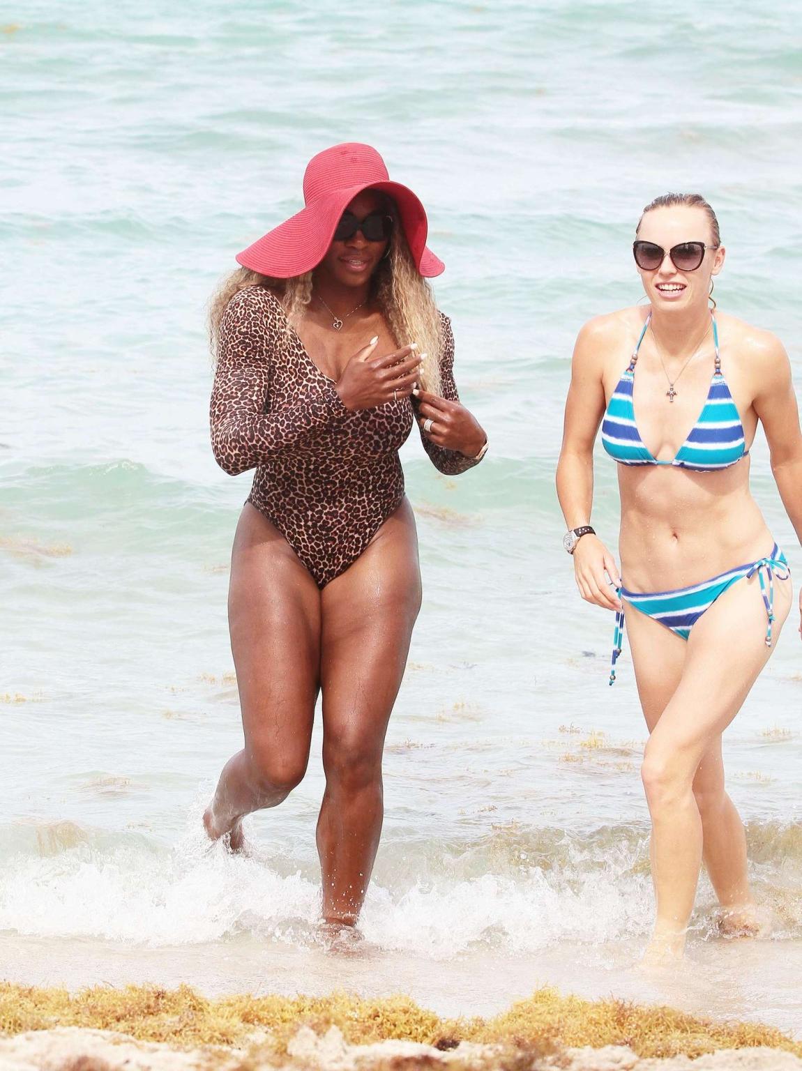 16P Serena Williams shows off her curvy body wearing a leopard print swimsuit on a b