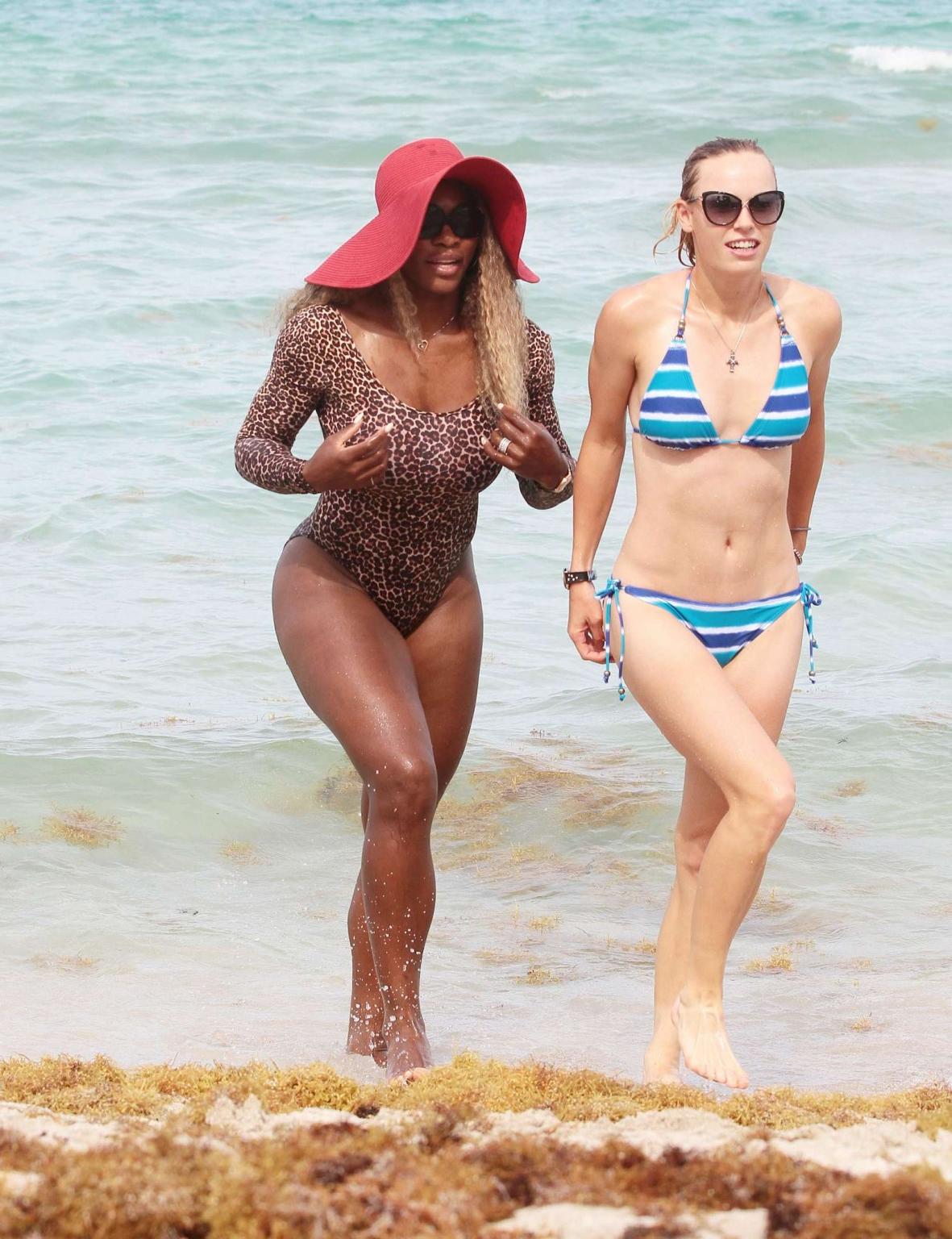 16P Serena Williams shows off her curvy body wearing a leopard print swimsuit on a b