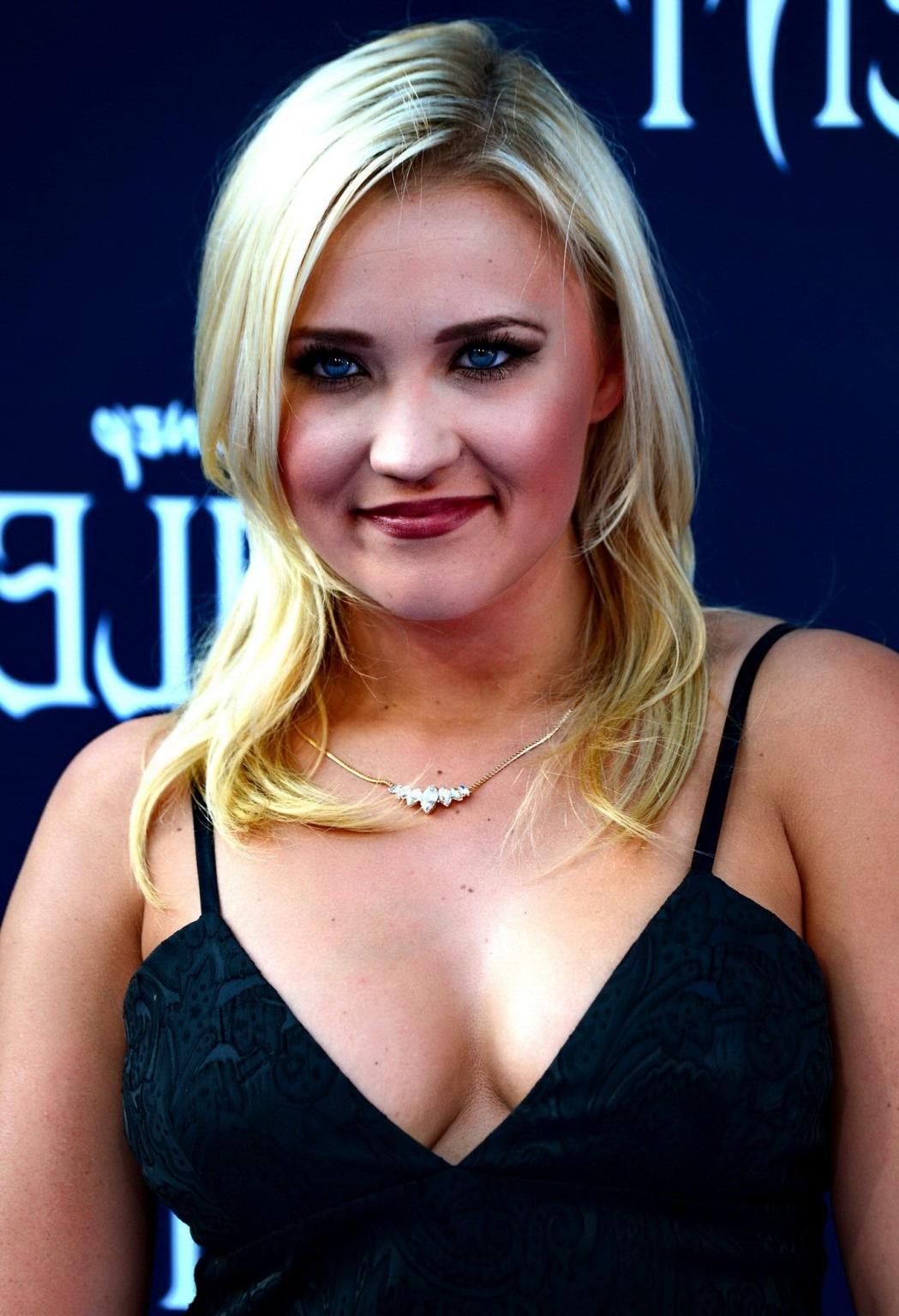 16P Busty Emily Osment wearing a low cut black dress at the Maleficent premiere in H