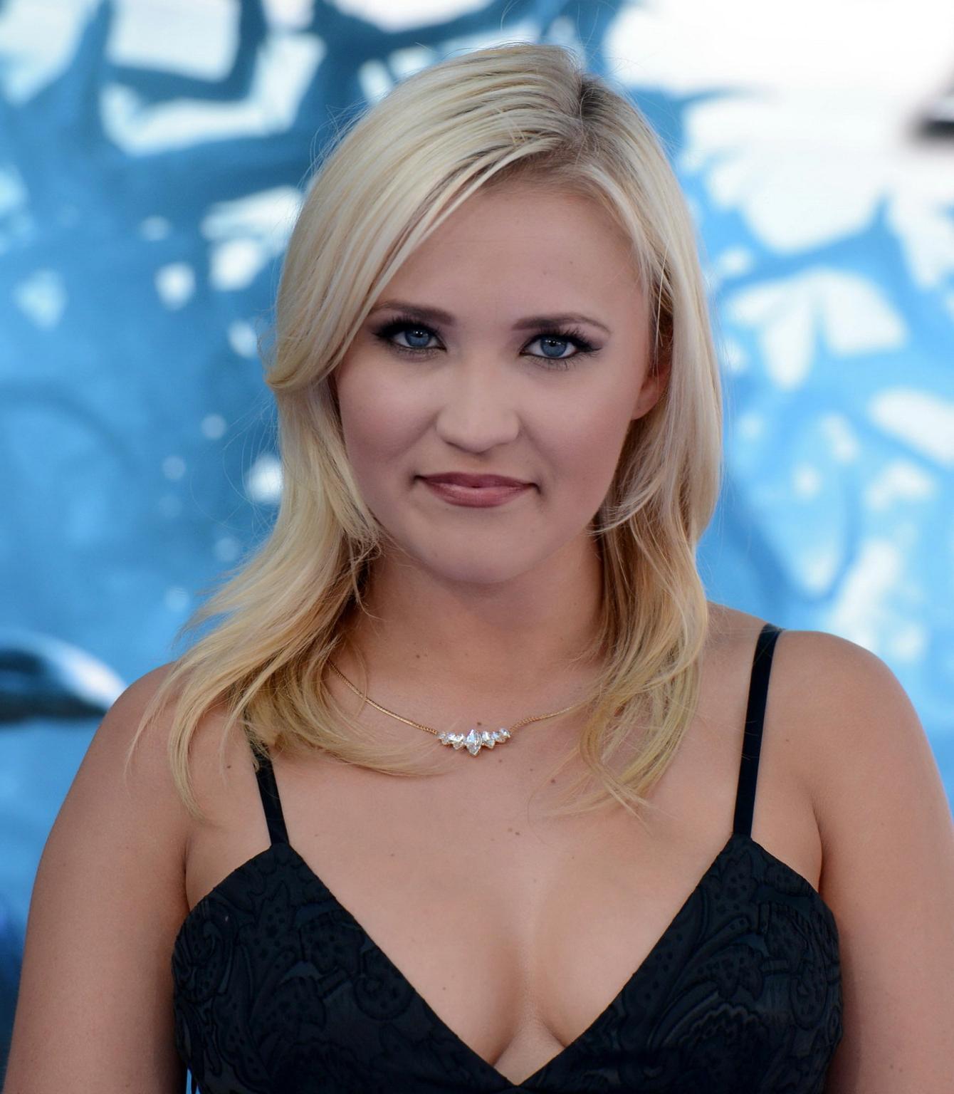 16P Busty Emily Osment wearing a low cut black dress at the Maleficent premiere in H