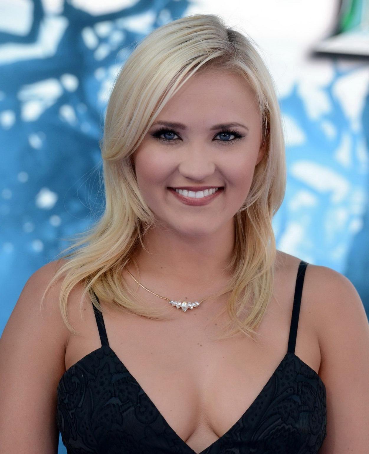 16P Busty Emily Osment wearing a low cut black dress at the Maleficent premiere in H