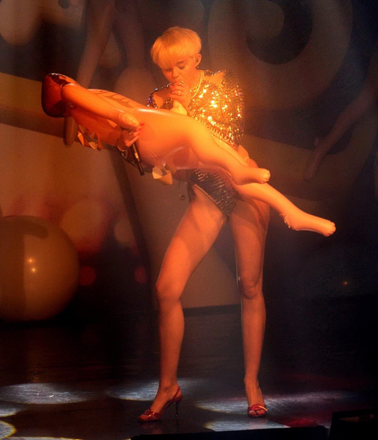 16P Miley Cyrus giving a blowjob to a blow up doll on stage at GAY Club in London