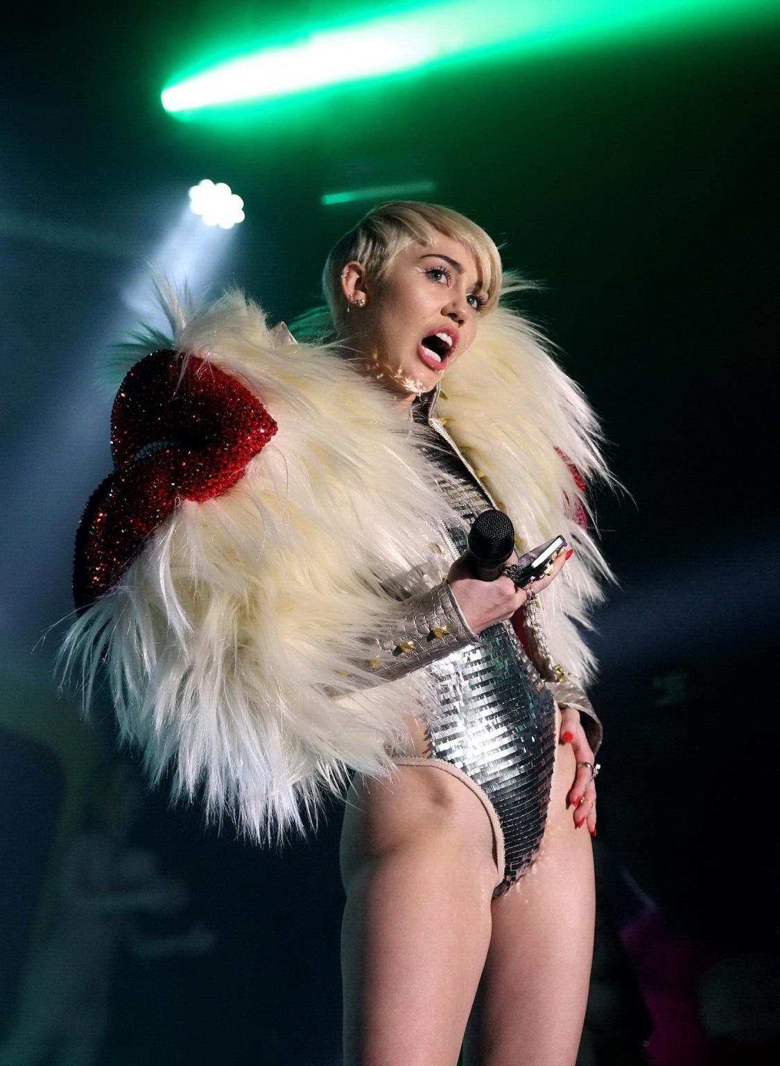 16P Miley Cyrus giving a blowjob to a blow up doll on stage at GAY Club in London