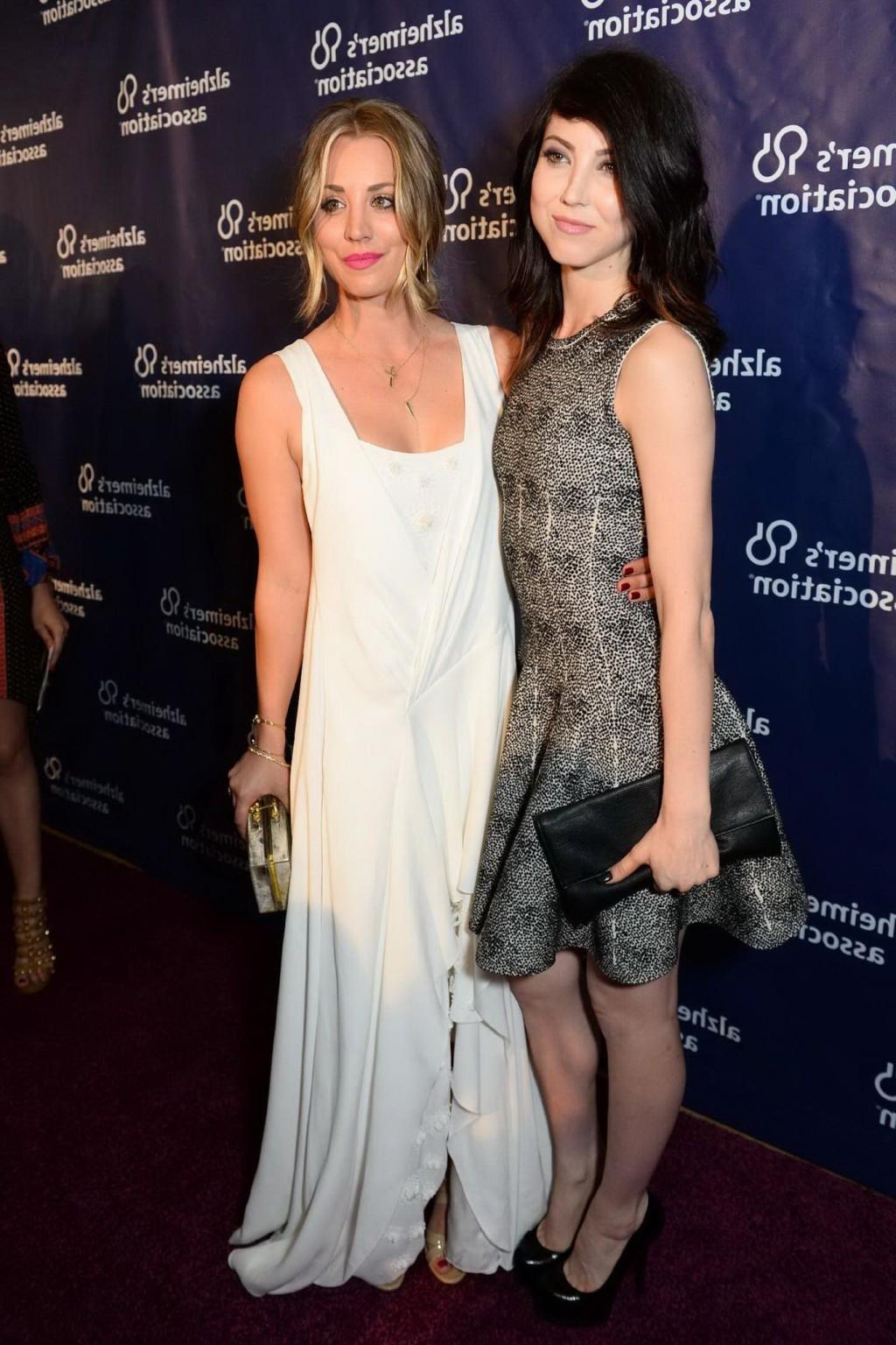 16P Kaley Cuoco showing big cleavage in white maxi dress