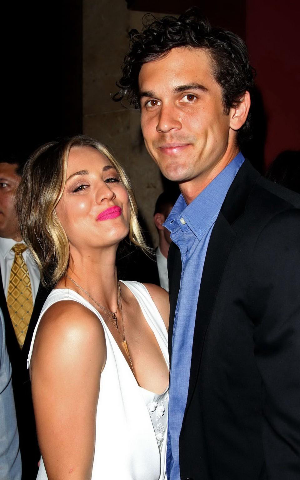 16P Kaley Cuoco showing big cleavage in white maxi dress