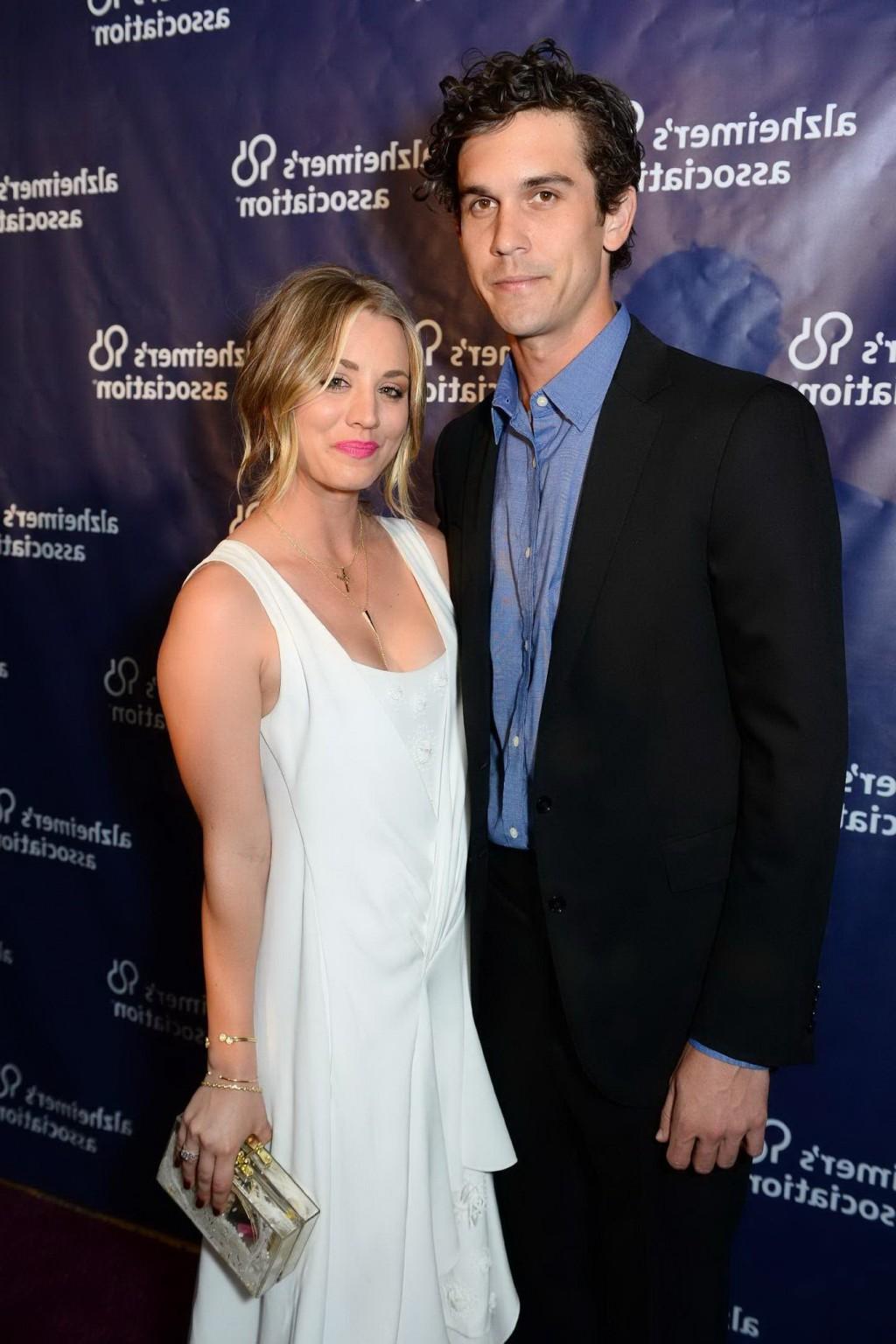 16P Kaley Cuoco showing big cleavage in white maxi dress