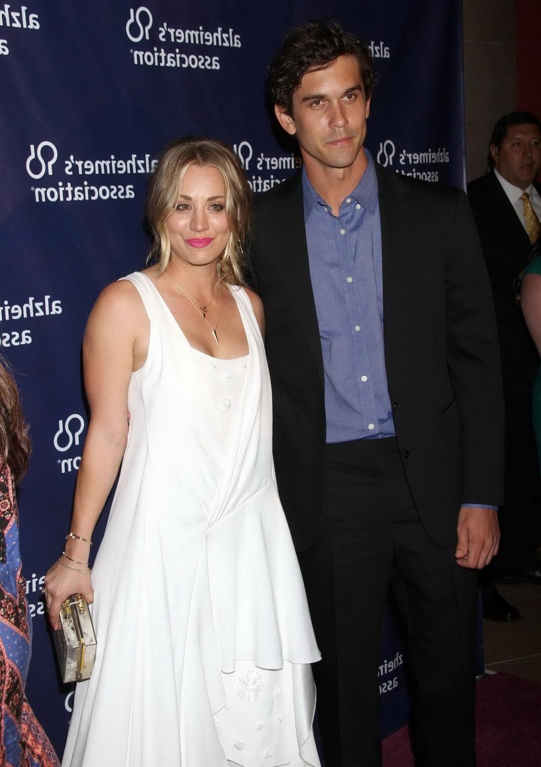 16P Kaley Cuoco showing big cleavage in white maxi dress