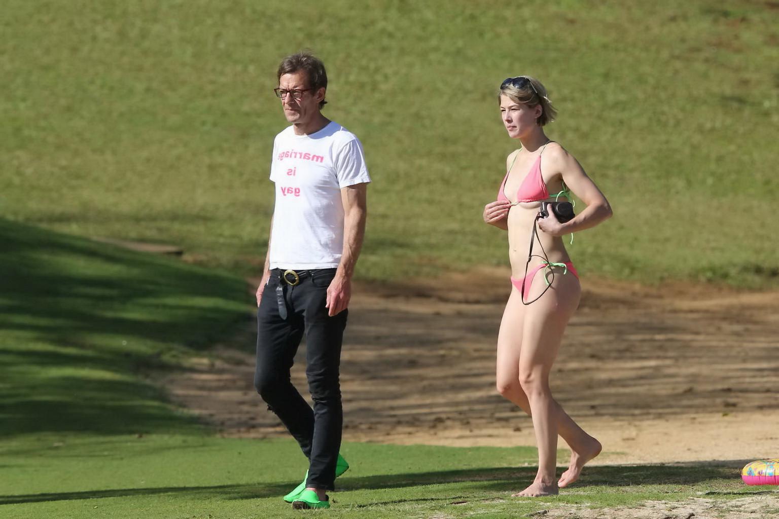16P Rosamund Pike wearing tiny pink bikini at the beach in Hawaii