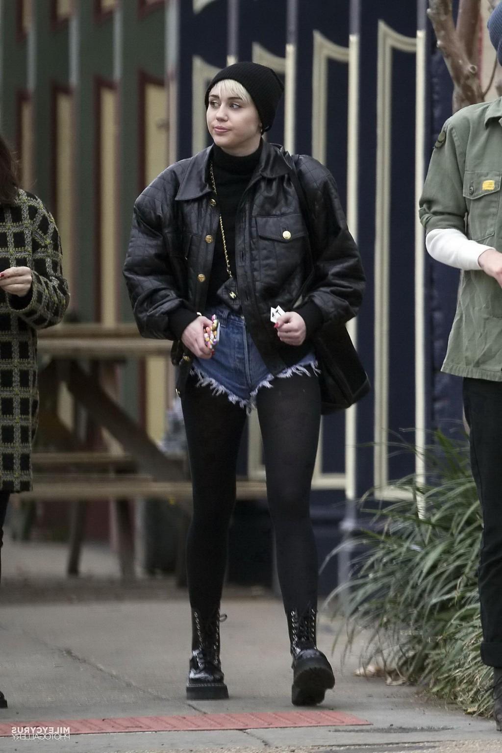 16P Miley Cyrus shows off her legs and ass wearing the denim shorts  black pantyhose