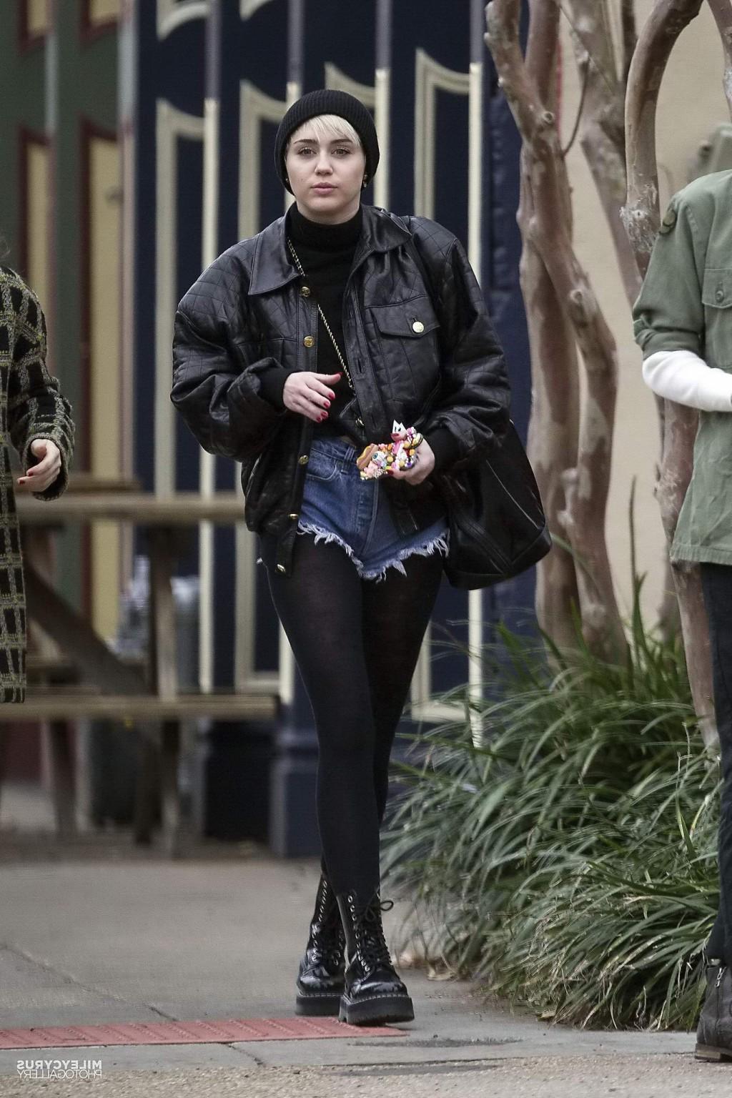 16P Miley Cyrus shows off her legs and ass wearing the denim shorts  black pantyhose