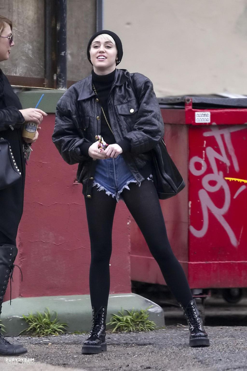 16P Miley Cyrus shows off her legs and ass wearing the denim shorts  black pantyhose