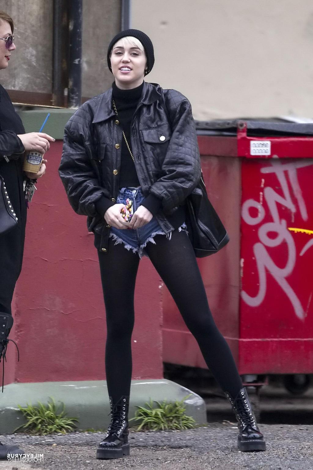 16P Miley Cyrus shows off her legs and ass wearing the denim shorts  black pantyhose
