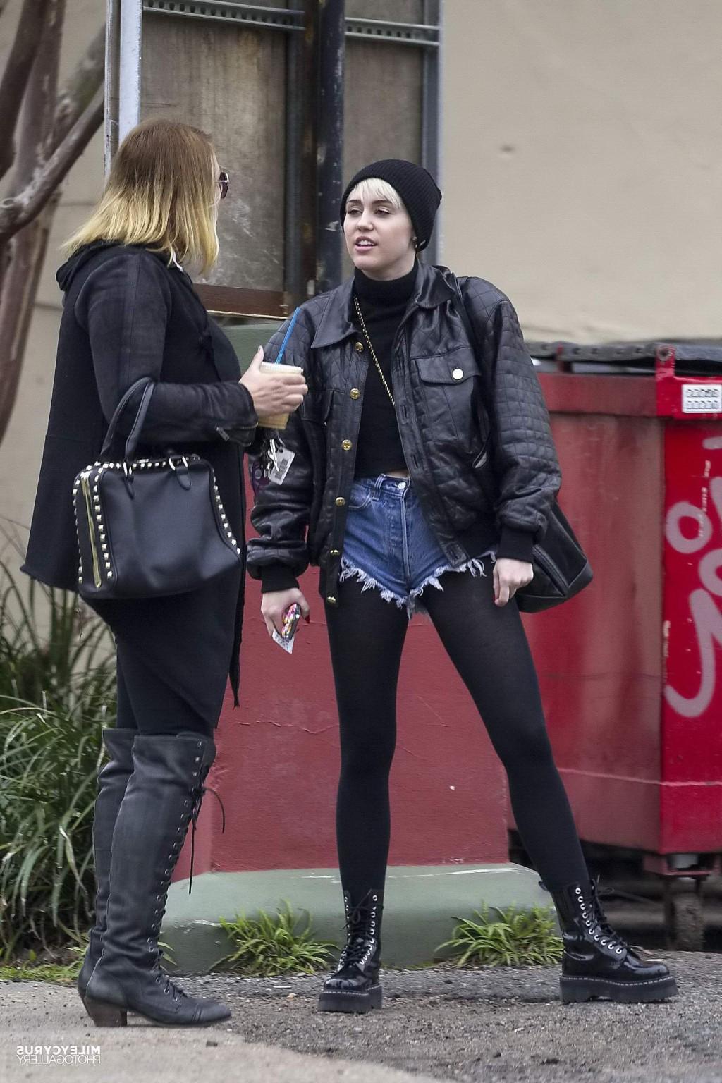 16P Miley Cyrus shows off her legs and ass wearing the denim shorts  black pantyhose