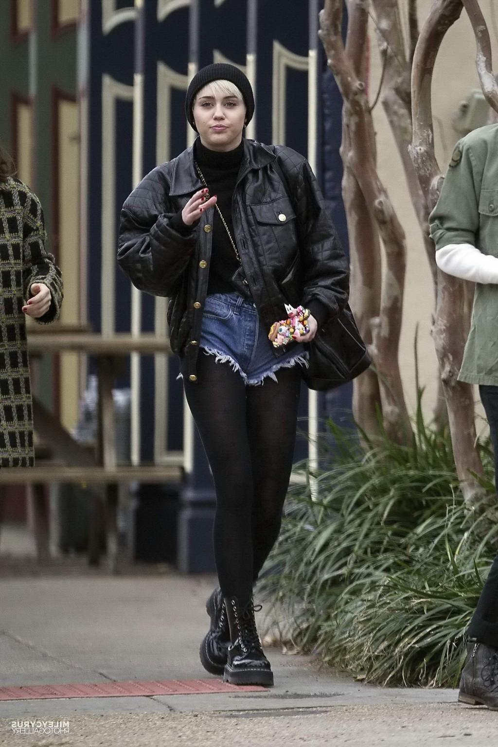 16P Miley Cyrus shows off her legs and ass wearing the denim shorts  black pantyhose