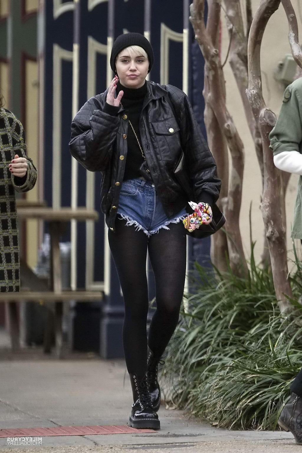 16P Miley Cyrus shows off her legs and ass wearing the denim shorts  black pantyhose