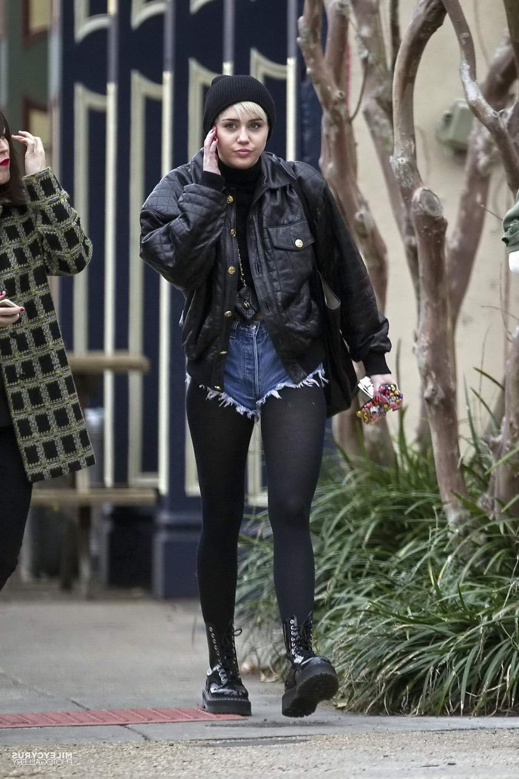 16P Miley Cyrus shows off her legs and ass wearing the denim shorts  black pantyhose