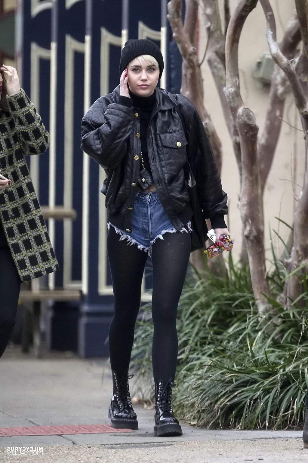 16P Miley Cyrus shows off her legs and ass wearing the denim shorts  black pantyhose