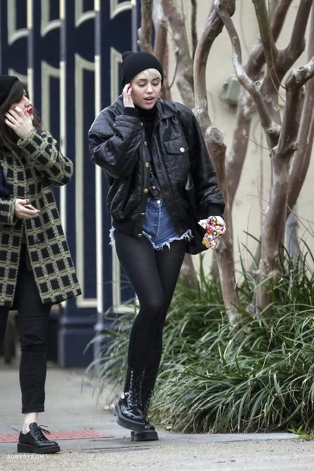 16P Miley Cyrus shows off her legs and ass wearing the denim shorts  black pantyhose