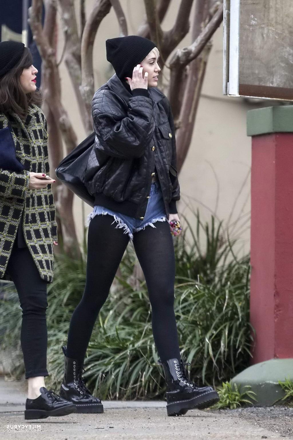 16P Miley Cyrus shows off her legs and ass wearing the denim shorts  black pantyhose