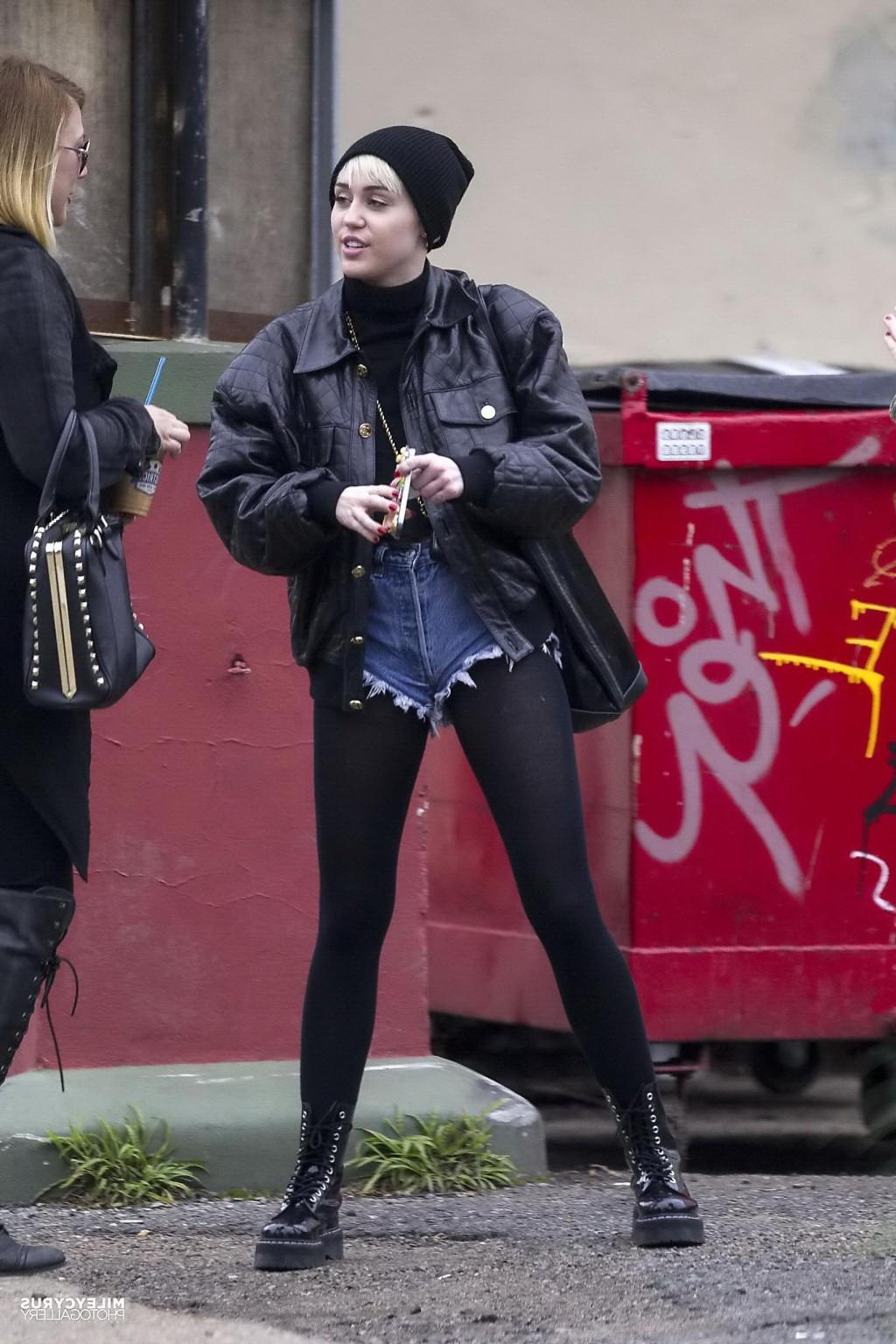 16P Miley Cyrus shows off her legs and ass wearing the denim shorts  black pantyhose