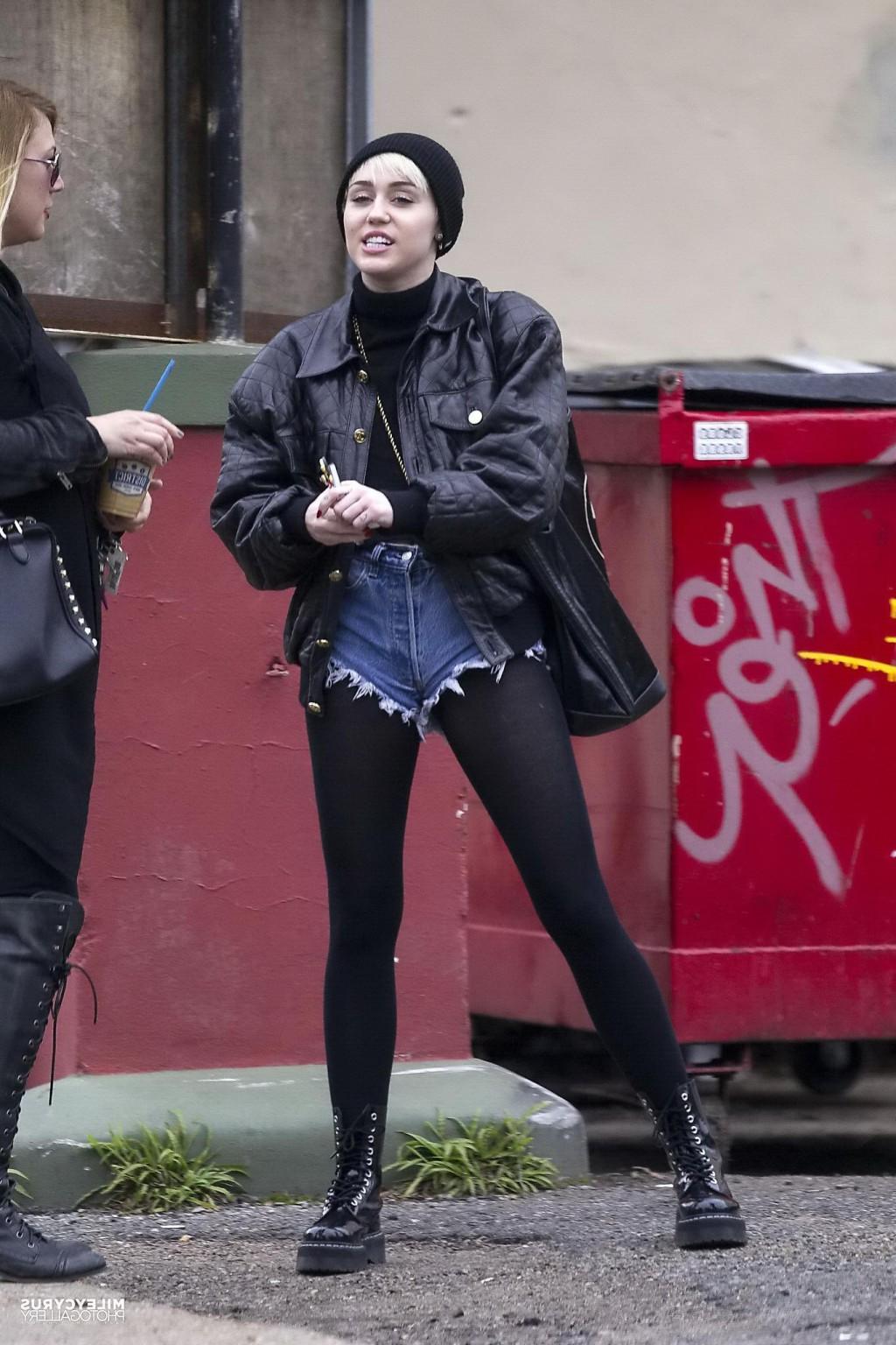 16P Miley Cyrus shows off her legs and ass wearing the denim shorts  black pantyhose