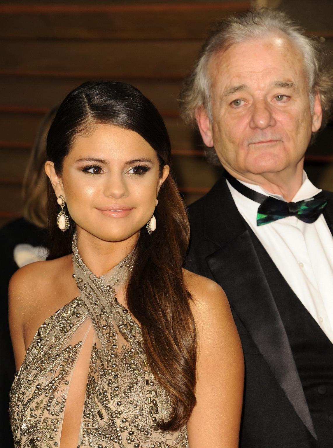 16P Selena Gomez braless wearing low cut partially see-thru dress at the Vanity Fair