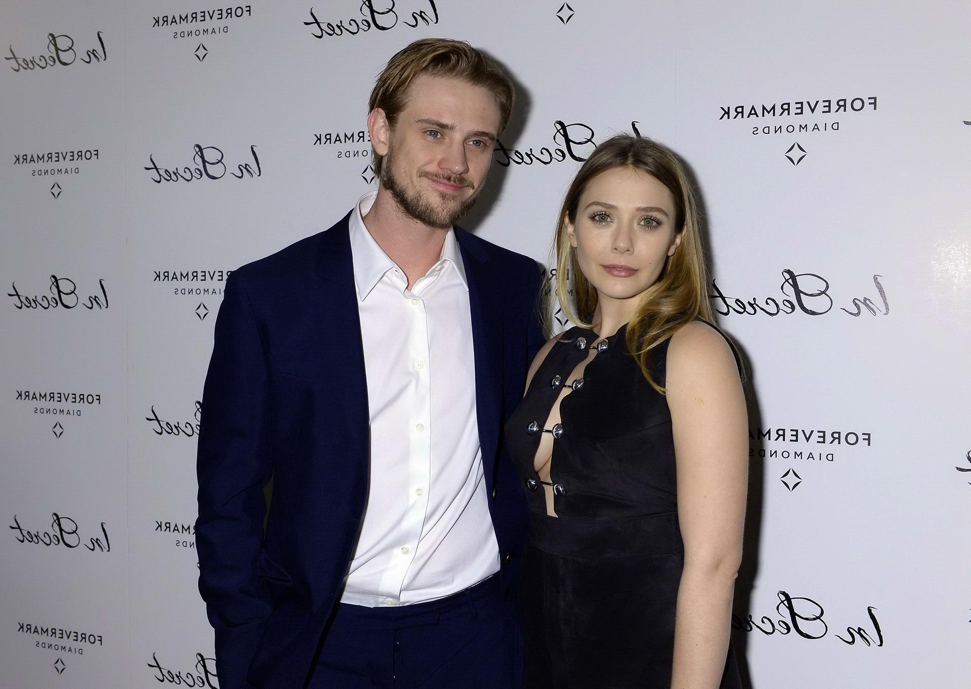 16P Elizabeth Olsen braless showing huge cleavage in a low cut black dress at the In