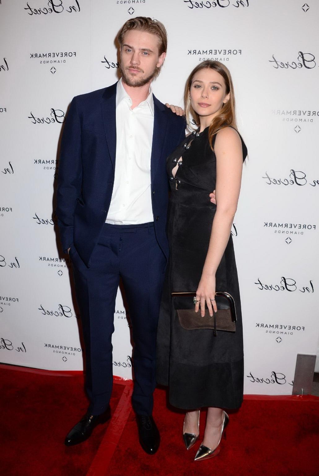 16P Elizabeth Olsen braless showing huge cleavage in a low cut black dress at the In