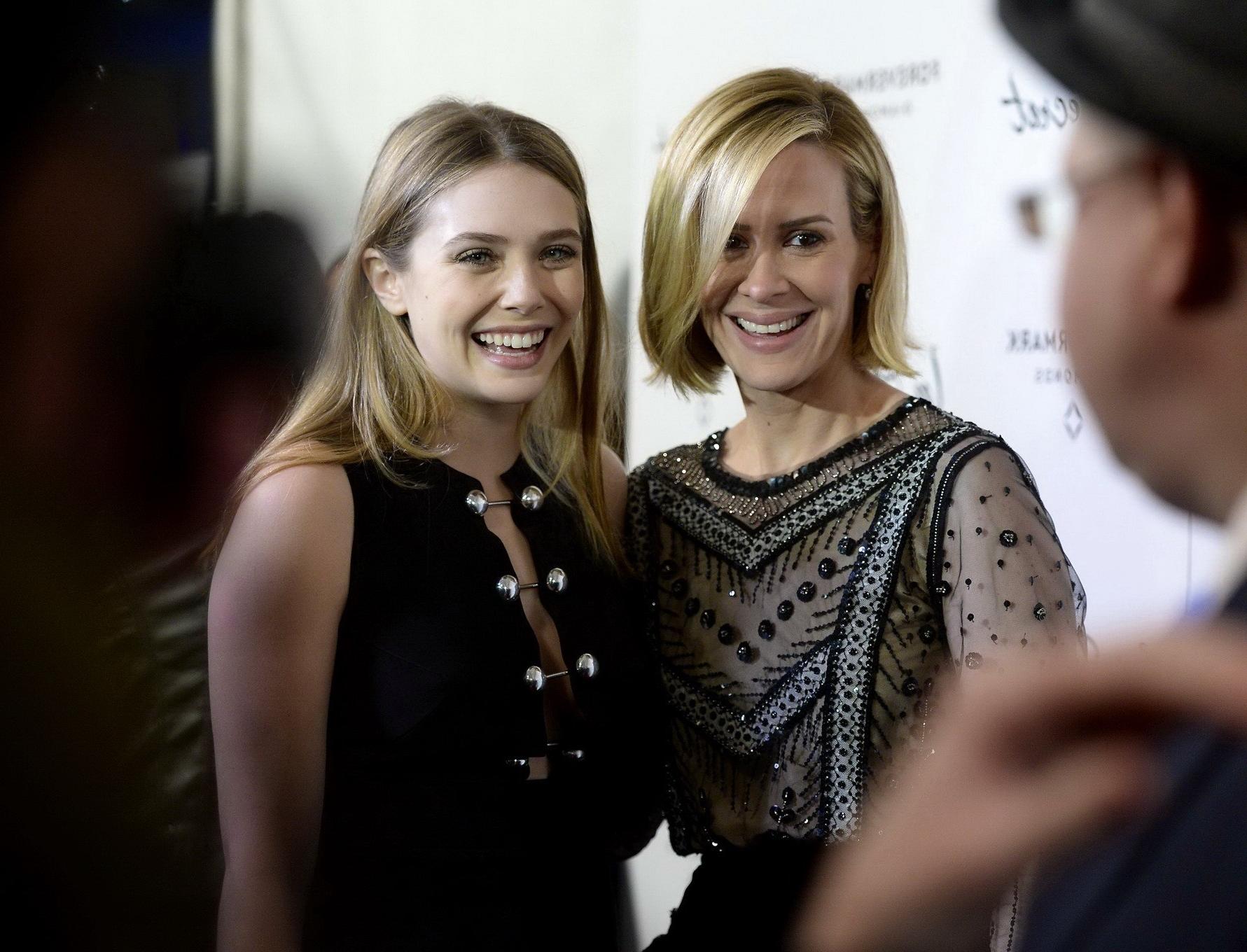 16P Elizabeth Olsen braless showing huge cleavage in a low cut black dress at the In