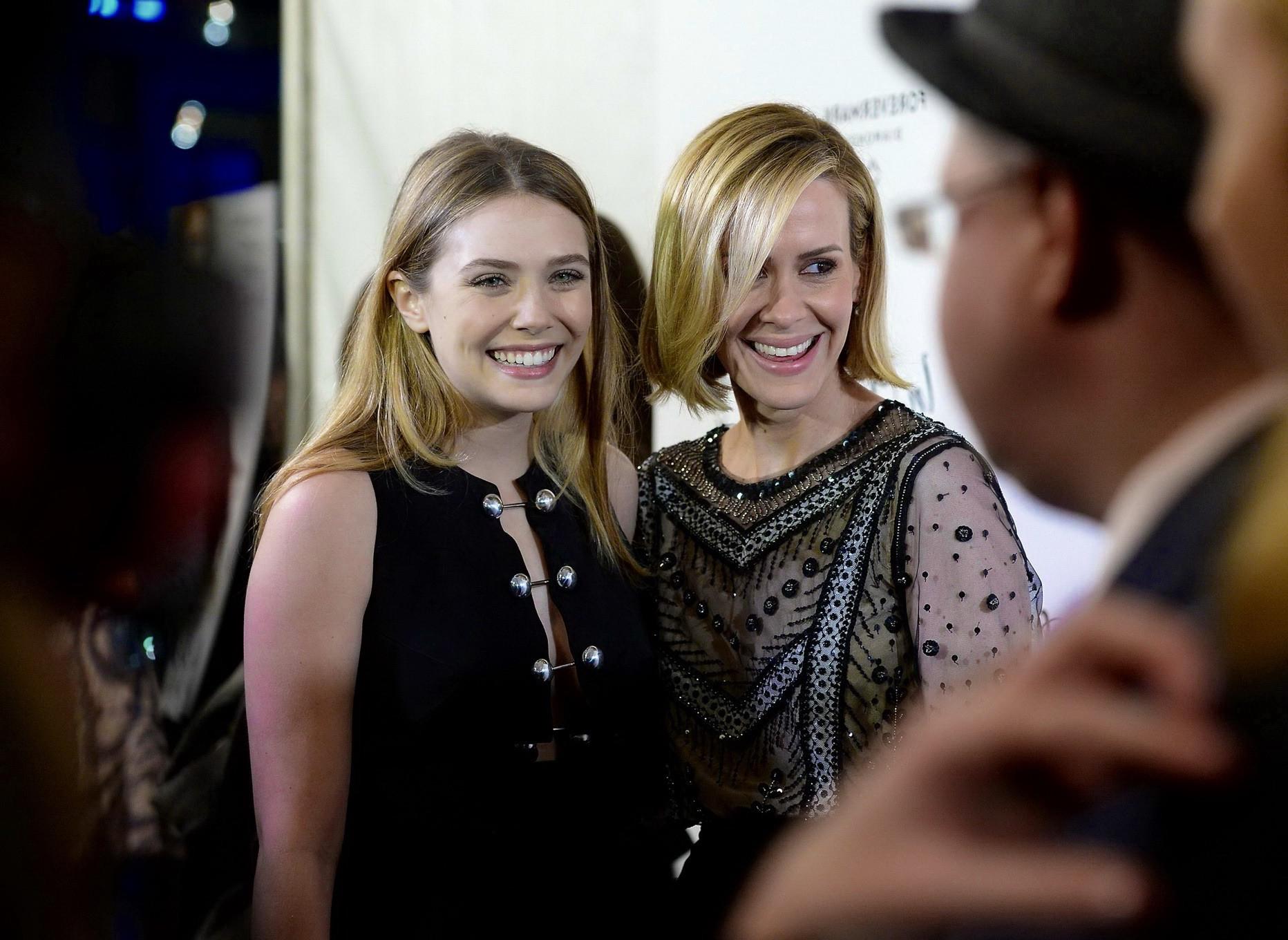 16P Elizabeth Olsen braless showing huge cleavage in a low cut black dress at the In