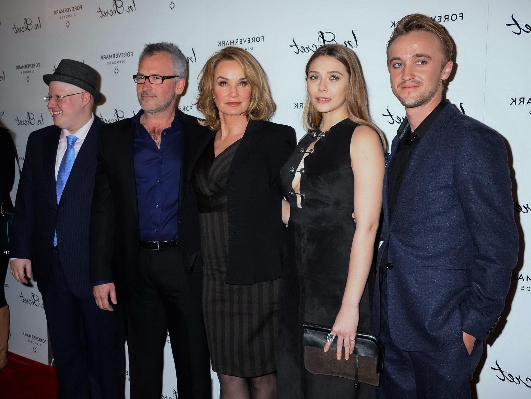 16P Elizabeth Olsen braless showing huge cleavage in a low cut black dress at the In