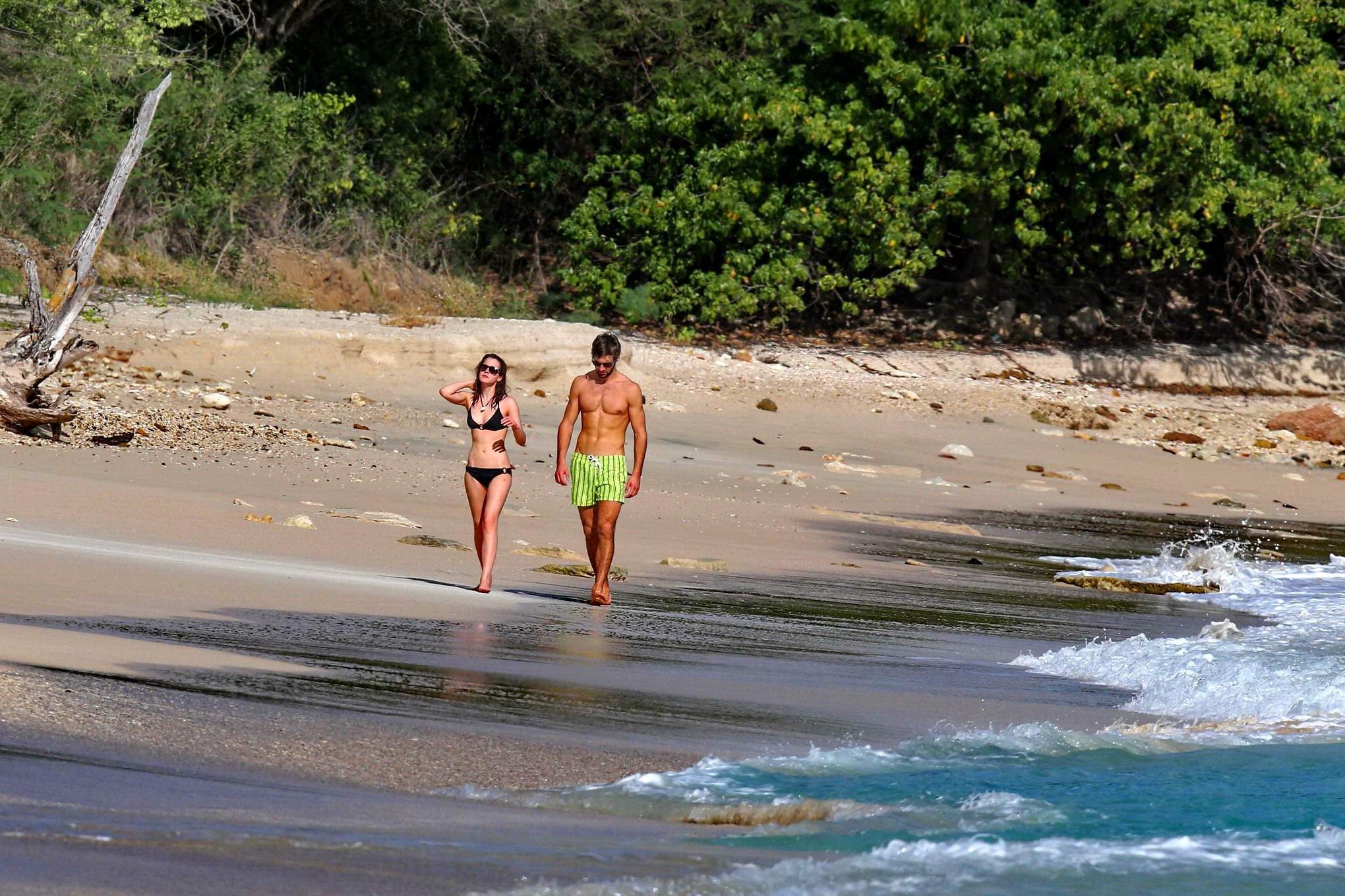 16P Emma Watson in black bikini petting with her boyfriend on a Carribean beach