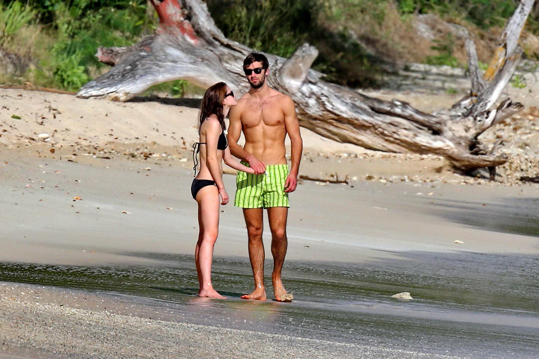 16P Emma Watson in black bikini petting with her boyfriend on a Carribean beach
