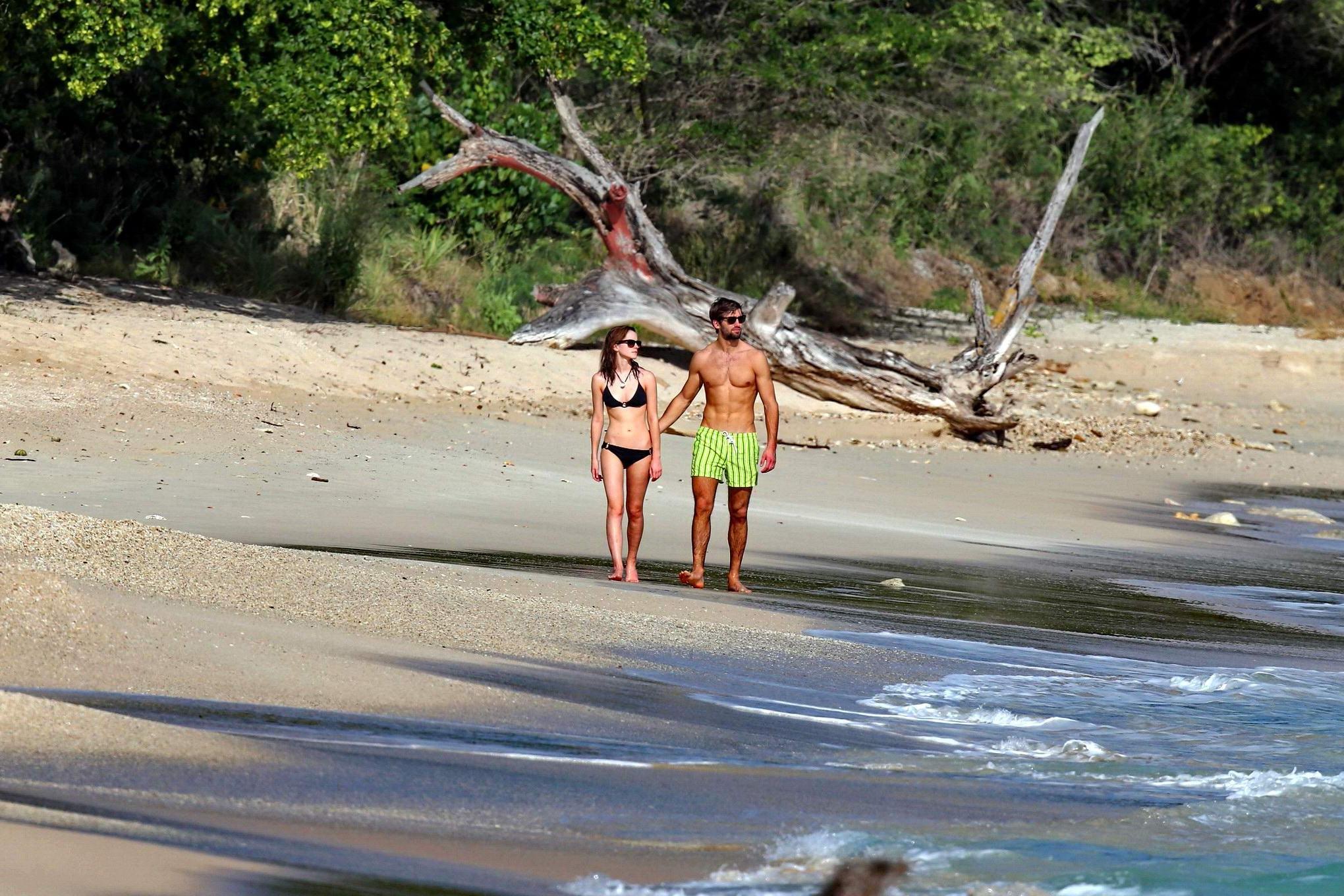 16P Emma Watson in black bikini petting with her boyfriend on a Carribean beach