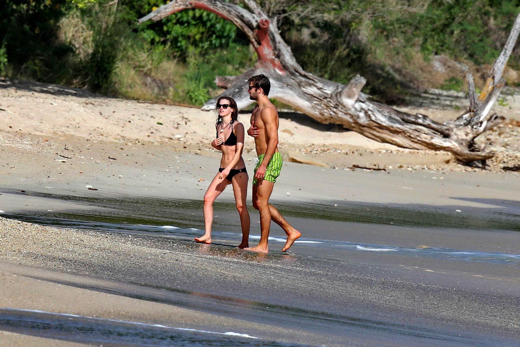 16P Emma Watson in black bikini petting with her boyfriend on a Carribean beach