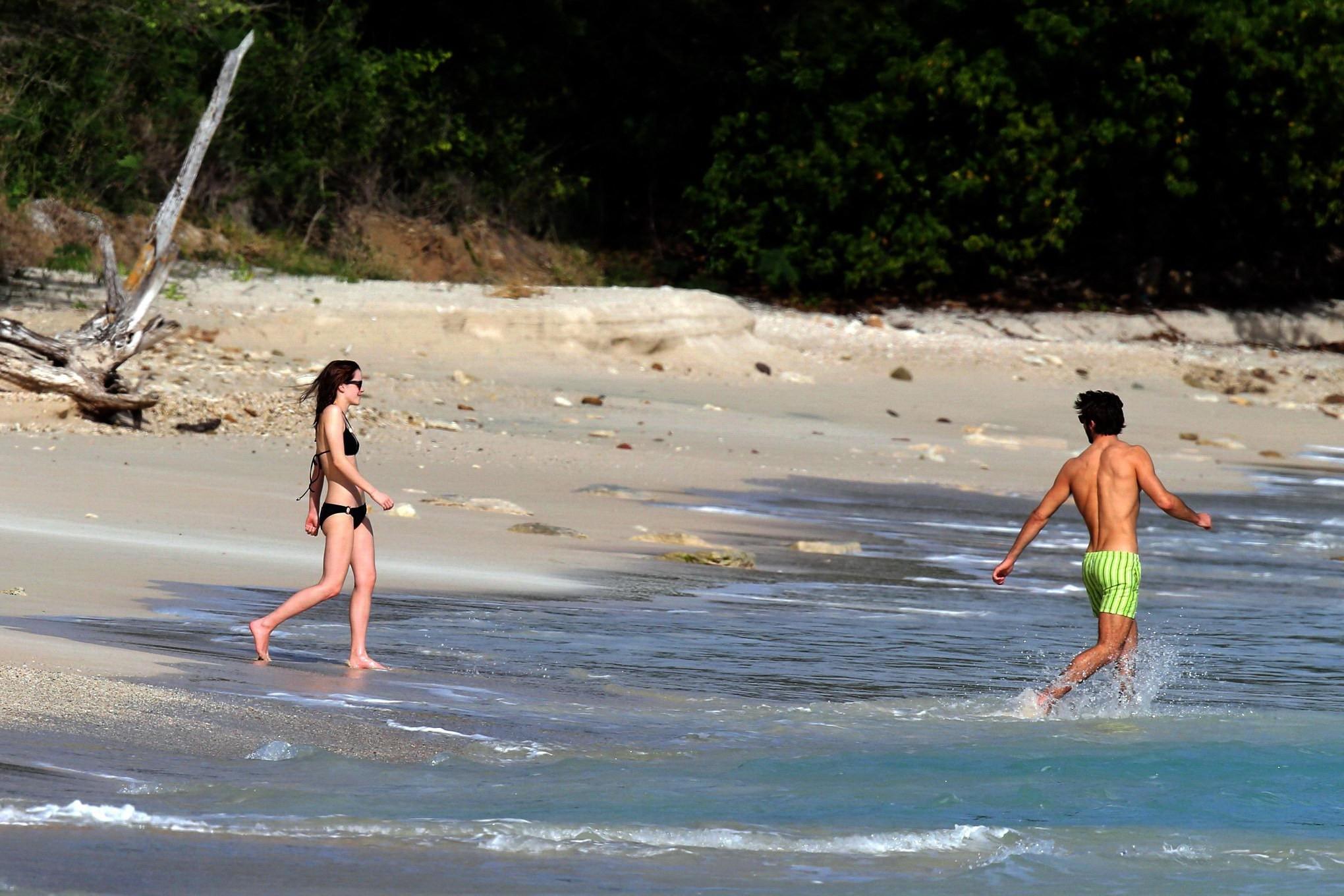 16P Emma Watson in black bikini petting with her boyfriend on a Carribean beach