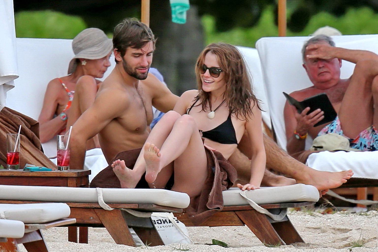 16P Emma Watson in black bikini petting with her boyfriend on a Carribean beach