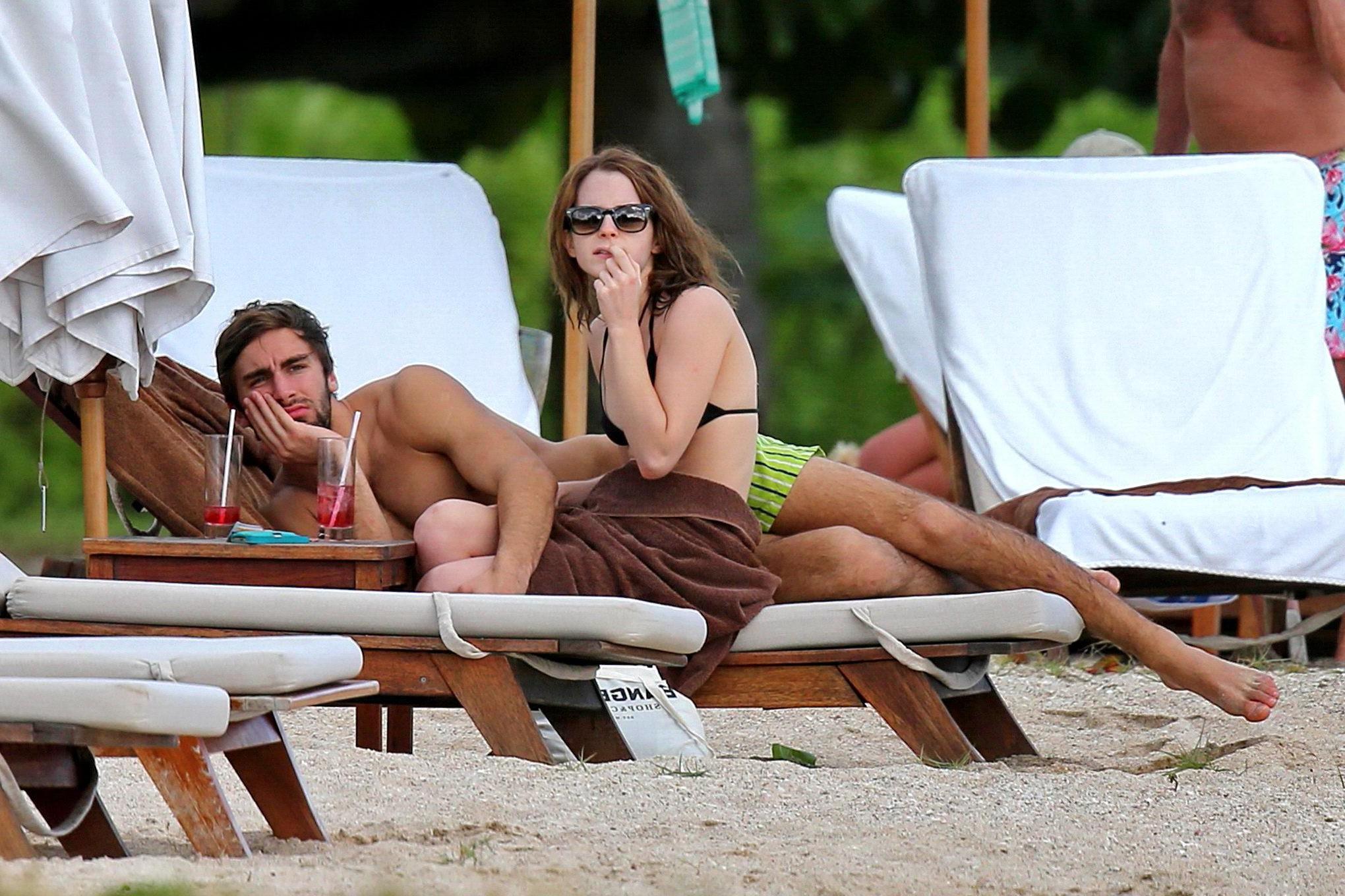 16P Emma Watson in black bikini petting with her boyfriend on a Carribean beach