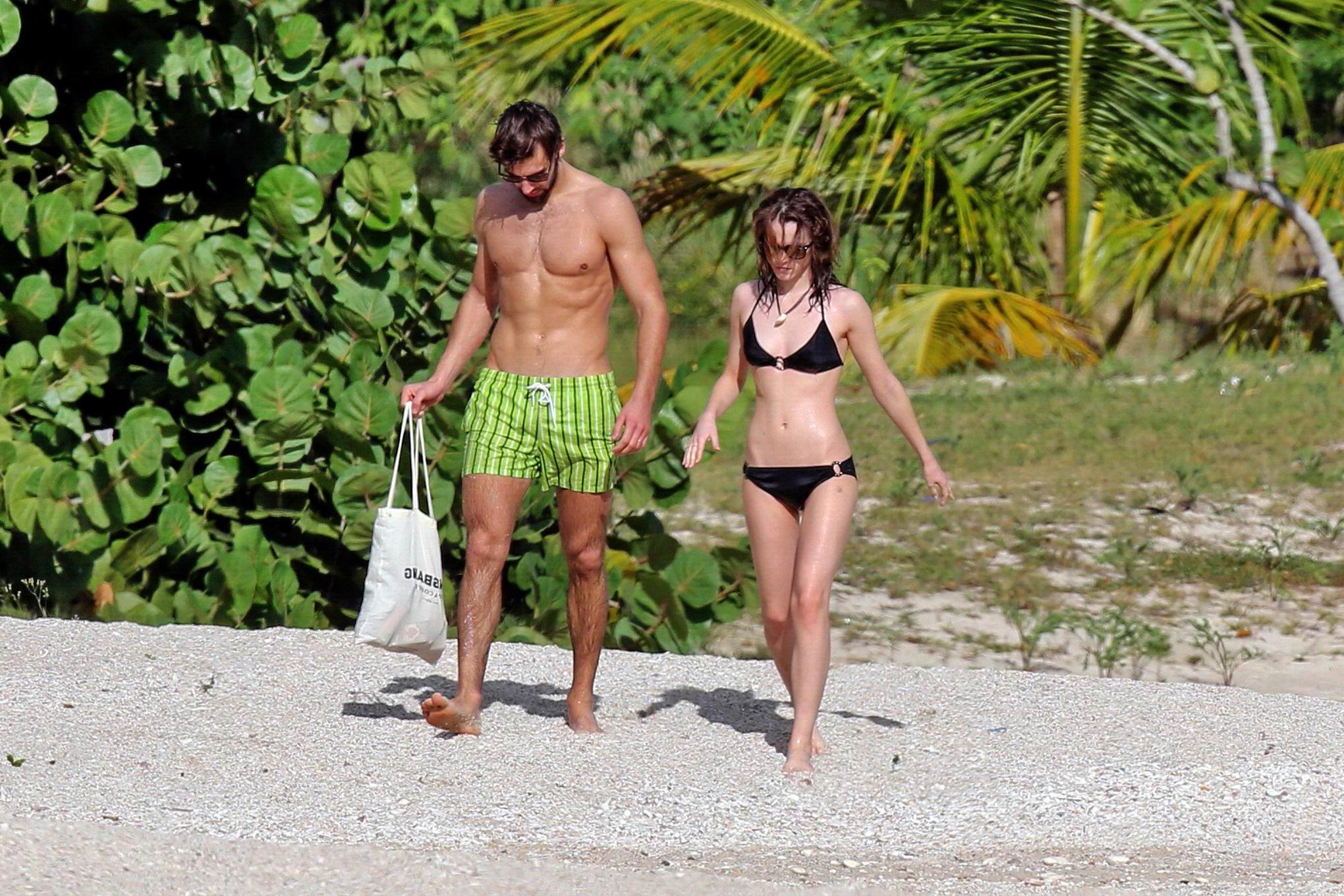 16P Emma Watson in black bikini petting with her boyfriend on a Carribean beach