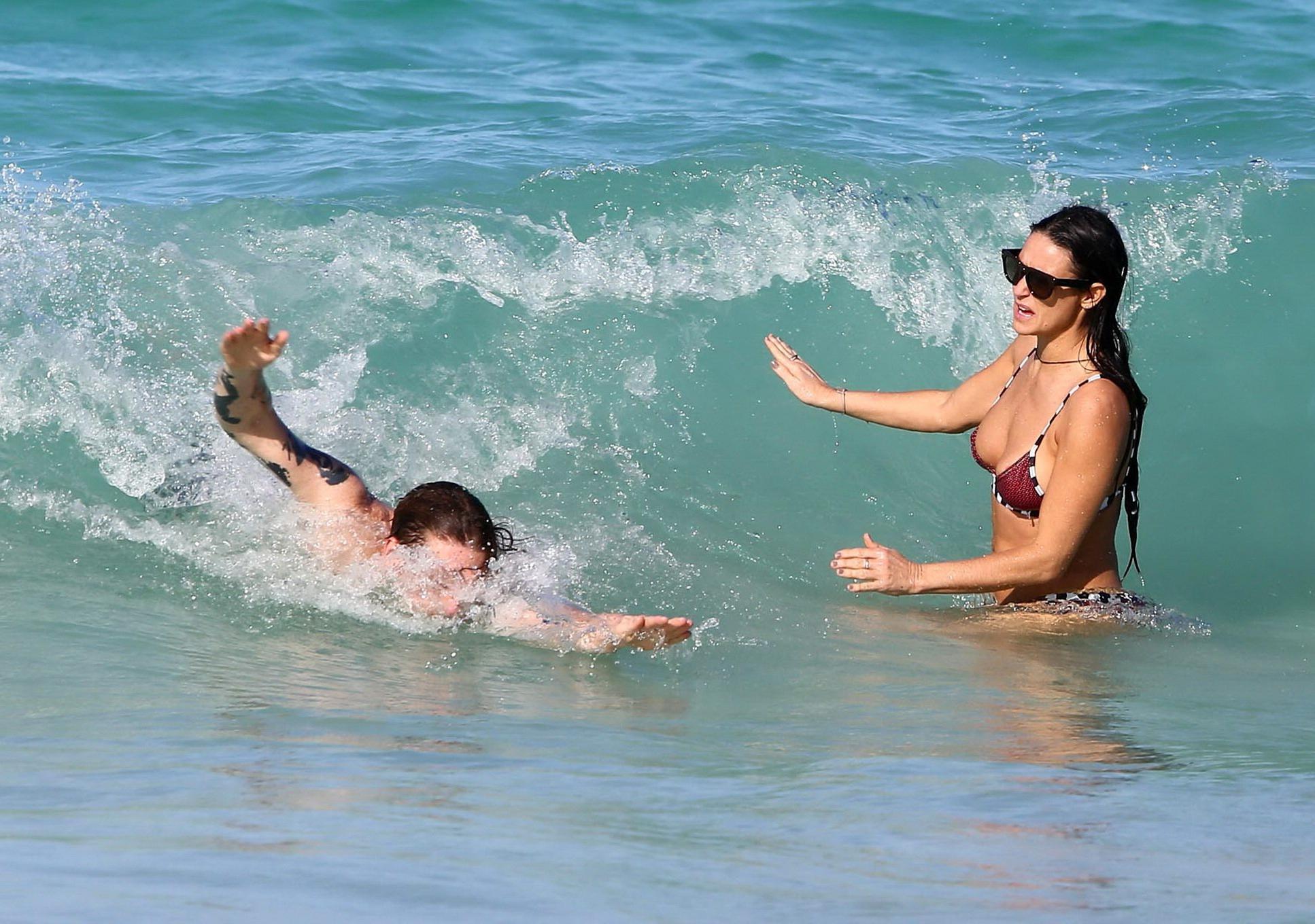 16P Demi Moore showing off her bikini body on a beach in Mexico