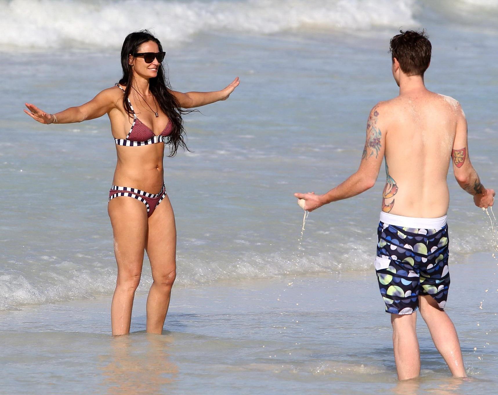 16P Demi Moore showing off her bikini body on a beach in Mexico