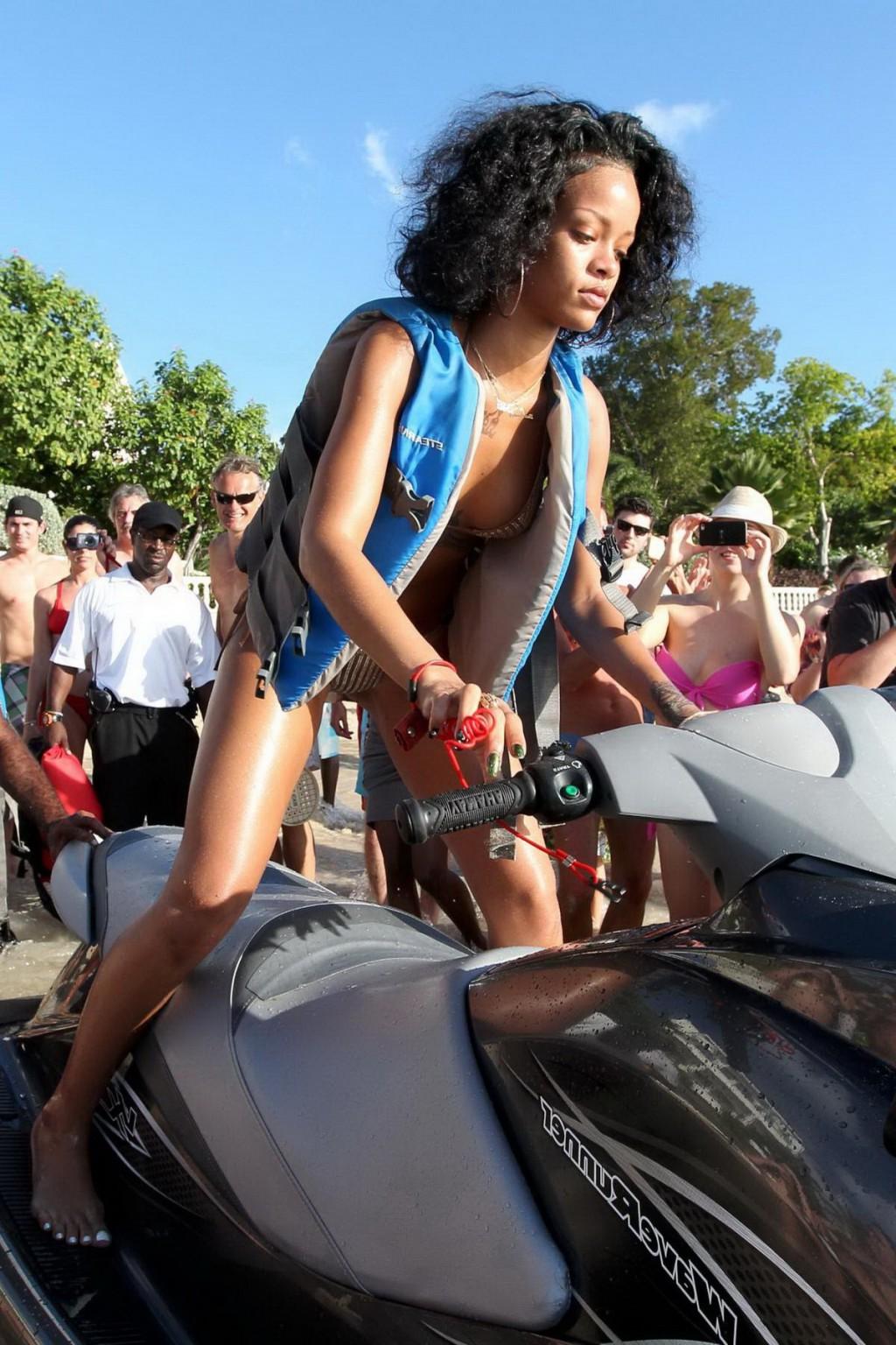 16P Rihanna showing off her perfect body in a wet string bikini at the beach in Barb