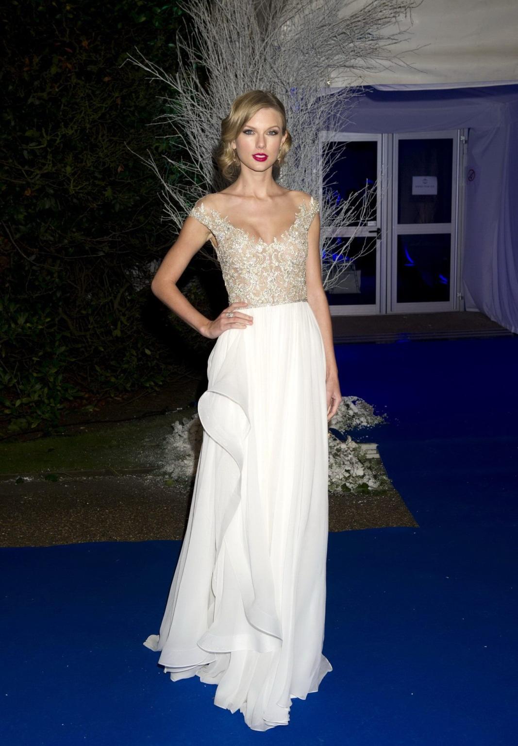 16P Taylor Swift braless wearing a tight partially see through dress at the Winter W