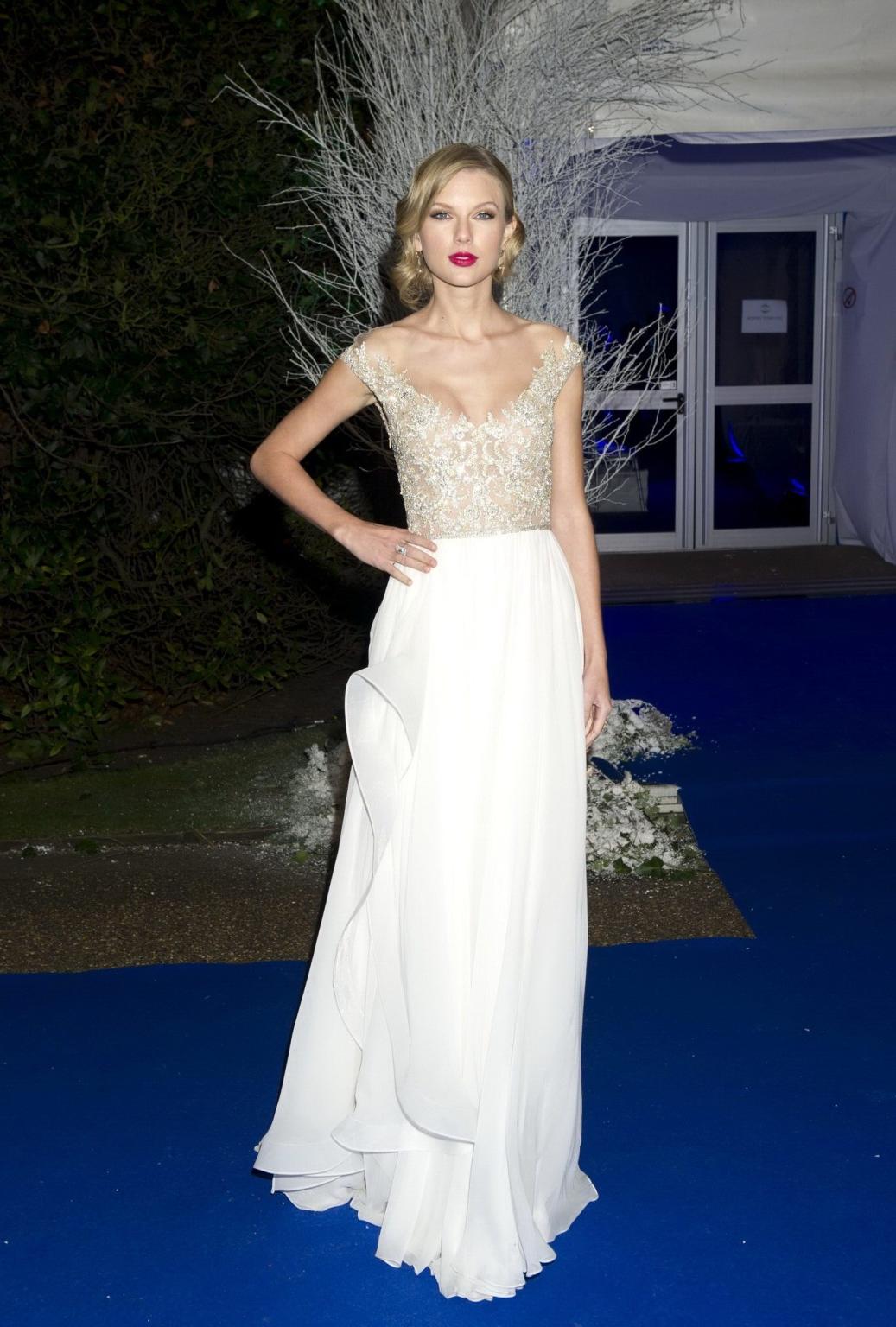 16P Taylor Swift braless wearing a tight partially see through dress at the Winter W