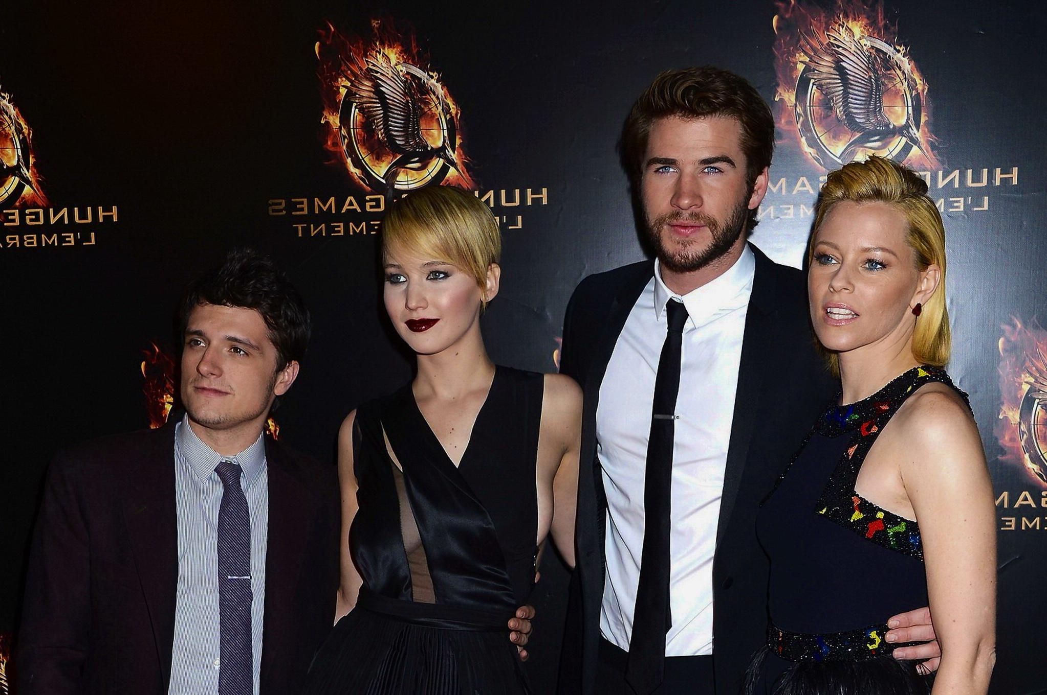 16P Jennifer Lawrence braless wearing skimpy black dress at The Hunger Games:Catchin