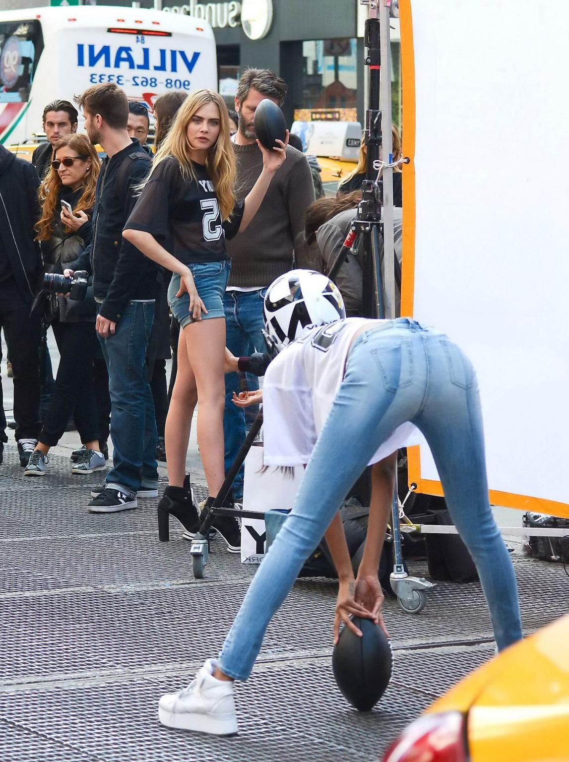 16P Cara Delevingne shows off her legs  ass wearing denim hotpants on the set of DKN