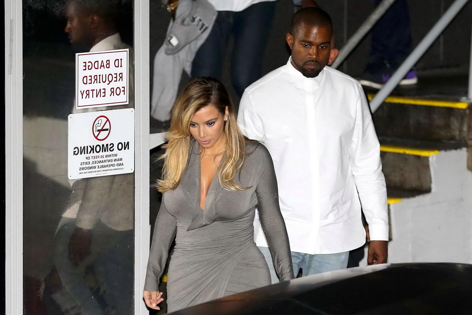 16P Kim Kardashian showing big cleavage in a high slit gray dress outside Dash bouti