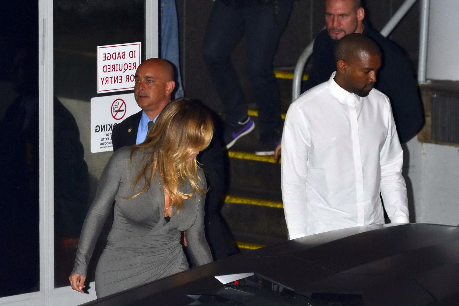 16P Kim Kardashian showing big cleavage in a high slit gray dress outside Dash bouti