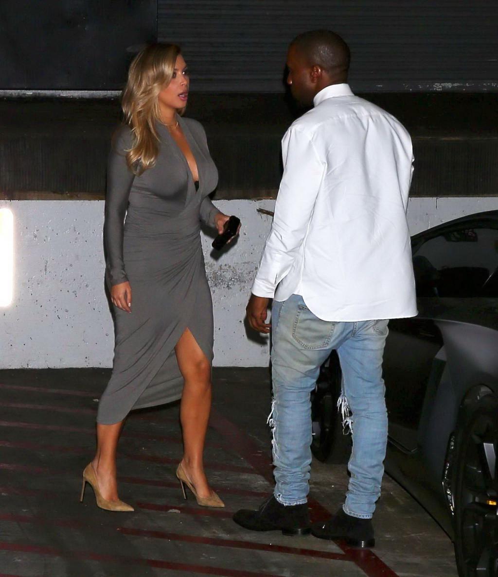 16P Kim Kardashian showing big cleavage in a high slit gray dress outside Dash bouti